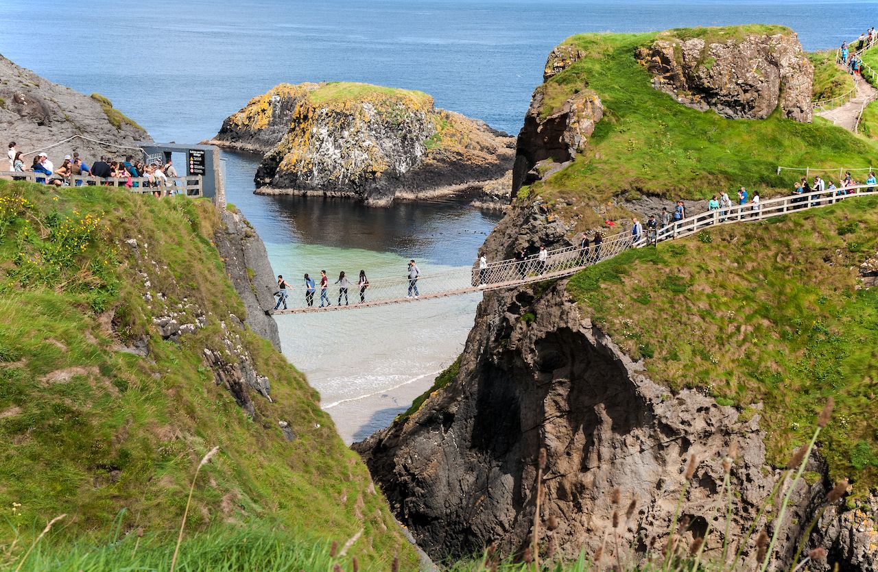 Tourist on the Carrick-a-Rede rope bridge on the Coast Causeway