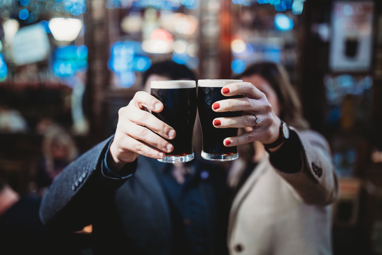 Young Man and Woman Drinking Guinness
