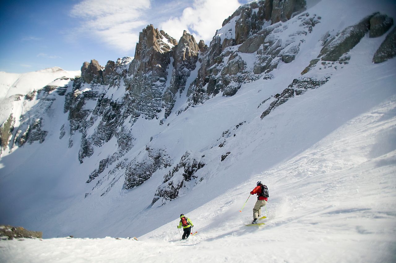 Two skiers descend Mountain Quail ski run at the Telluride Ski resort Telluride Colorado