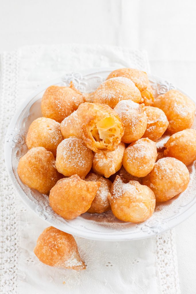 donuts with powdered sugar on a white background