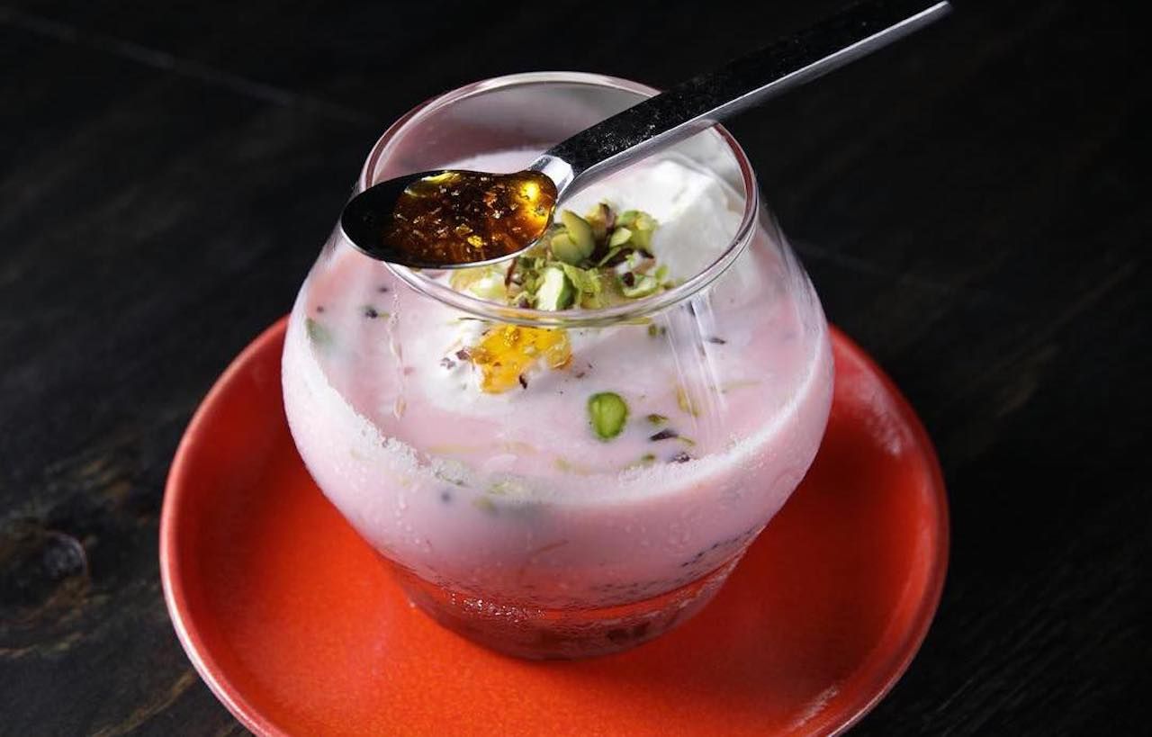 Cup of pink, pistachio-flavored Indian dessert