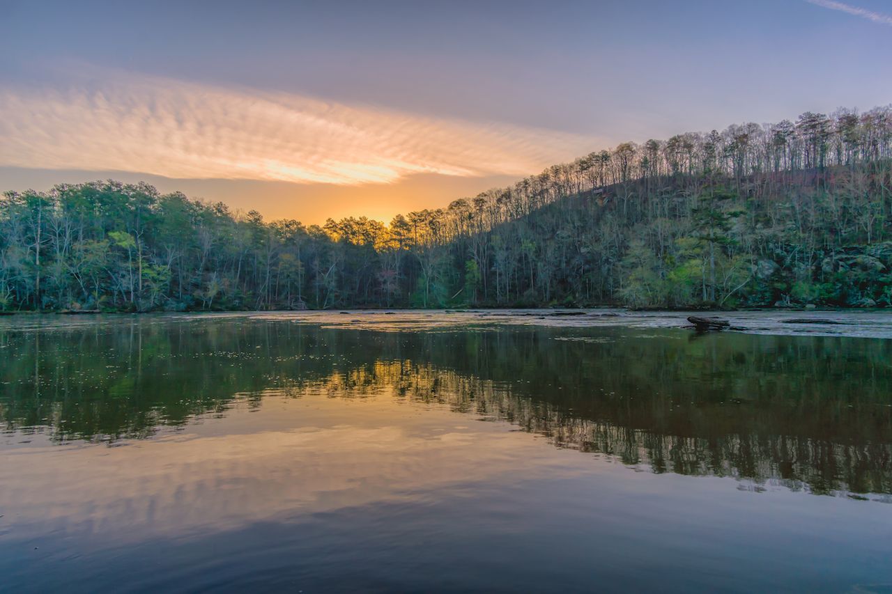 Reflection of the sky and river bank of the cattahoochee just before sunrise