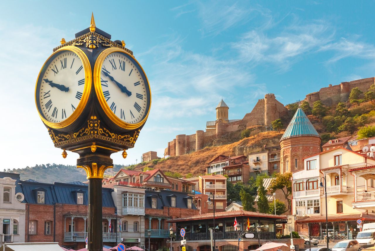 Amazing view of City clock, Old Meidan Square and Narikala ancient fortress in the sunny morning, Tbilisi, Georgia.