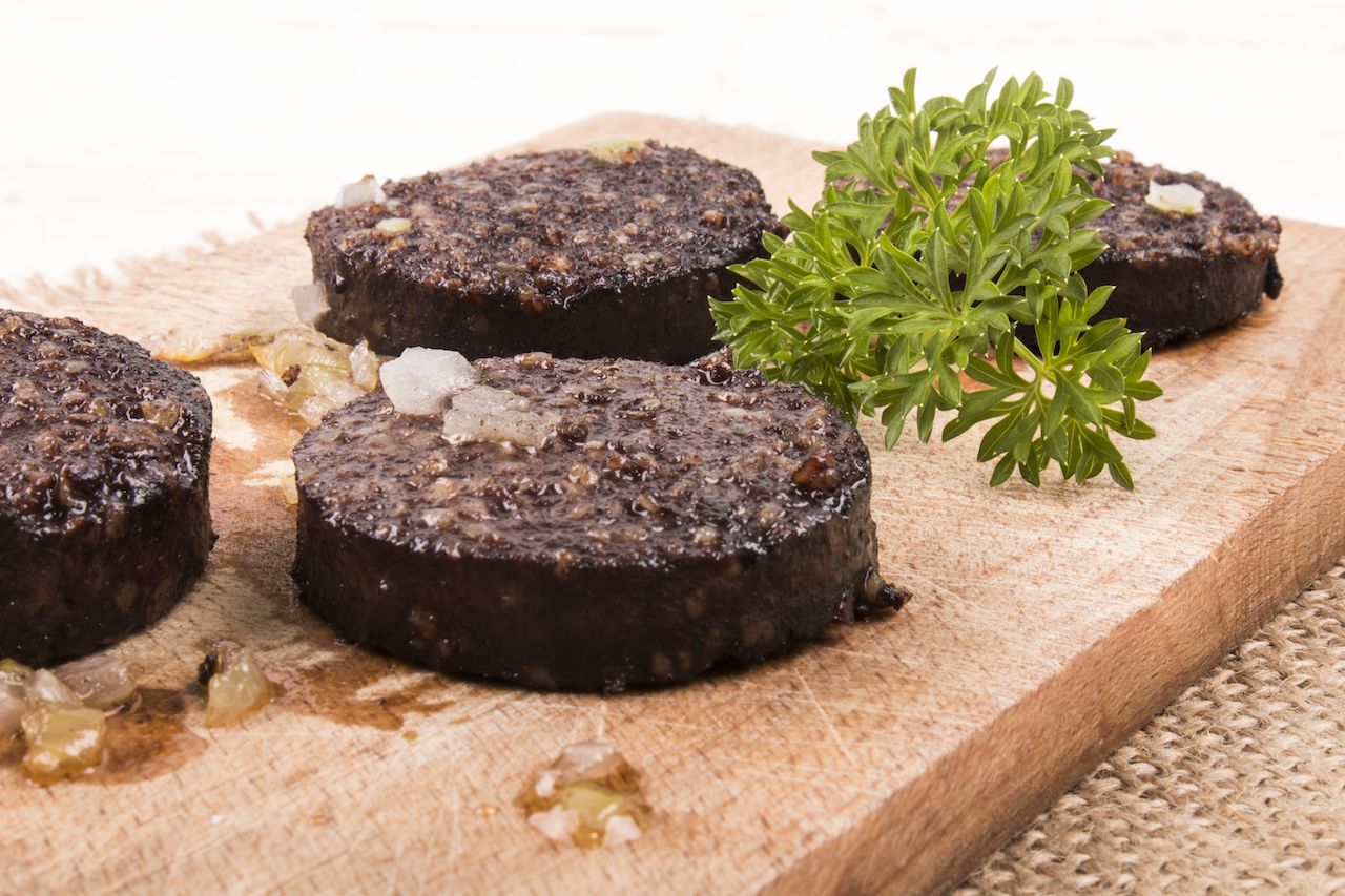 round cuts of Black pudding on a cutting board-Scottish foods
