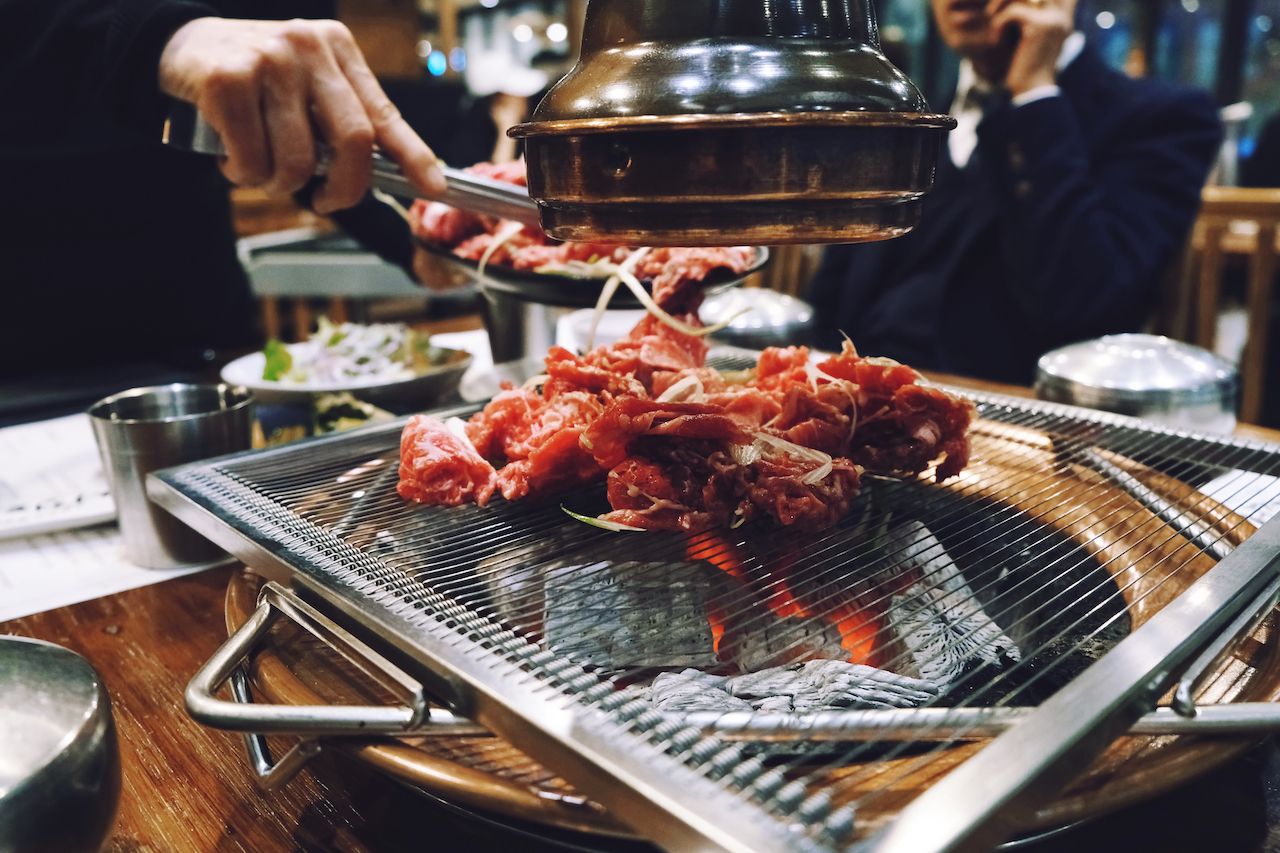 Grilling meat in a Korean restaurant