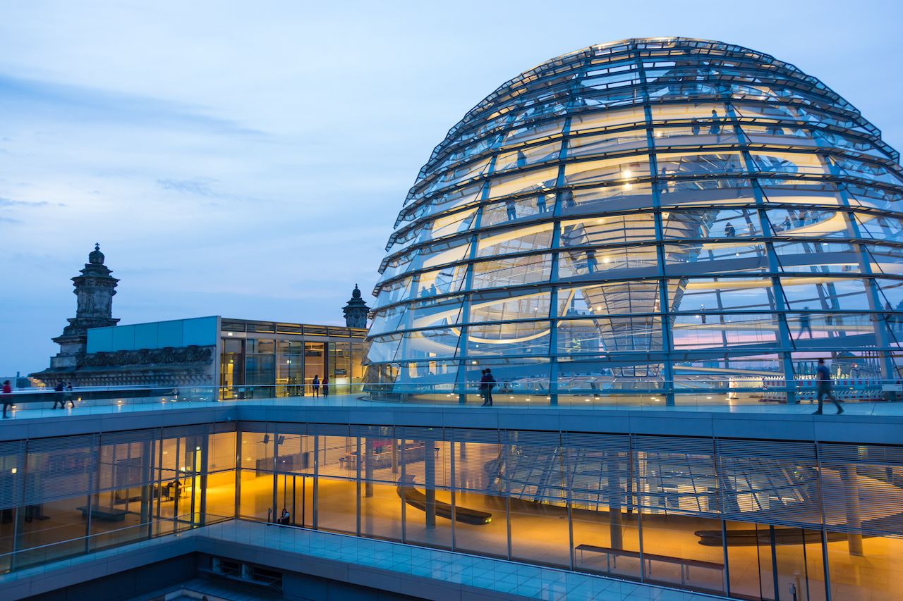 Illuminated glass dome on the roof of the Reichstag in Berlin in the late evening