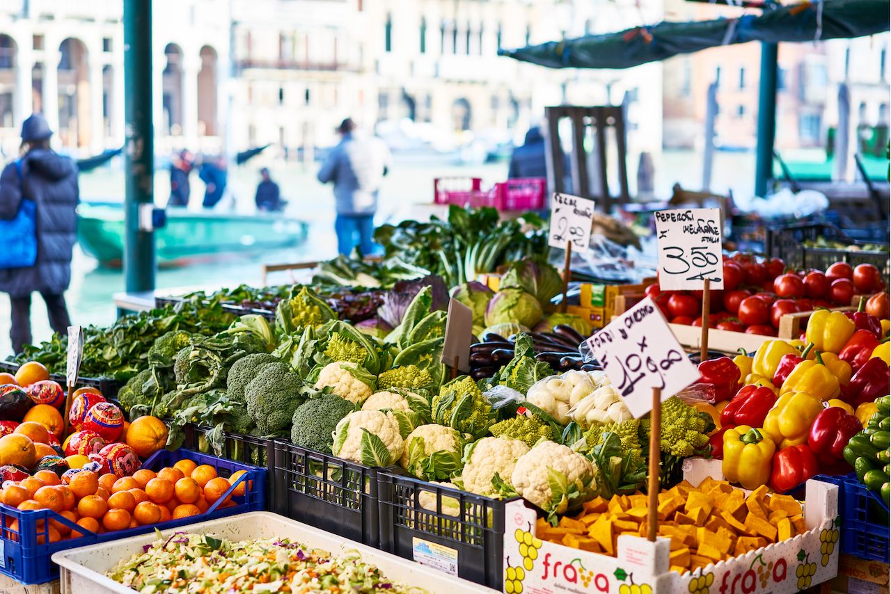 Market stall with vegetables and fruits in Venice Italy with sun Rialto