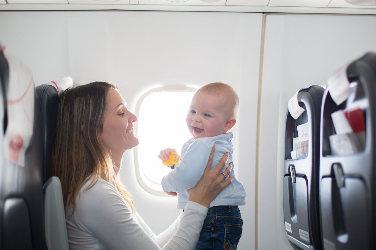 Parent playing with baby on a plane