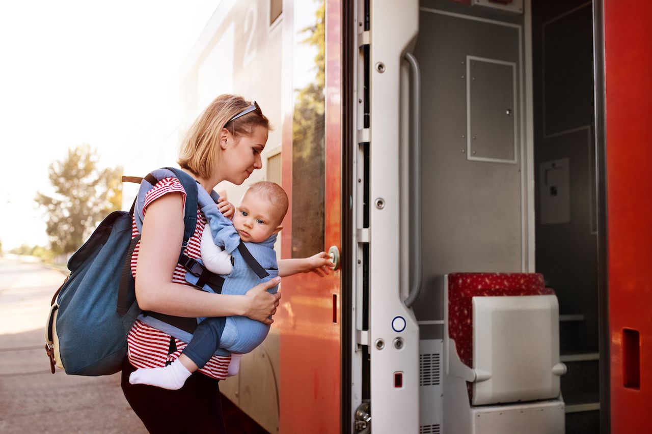 Parent traveling with baby by train