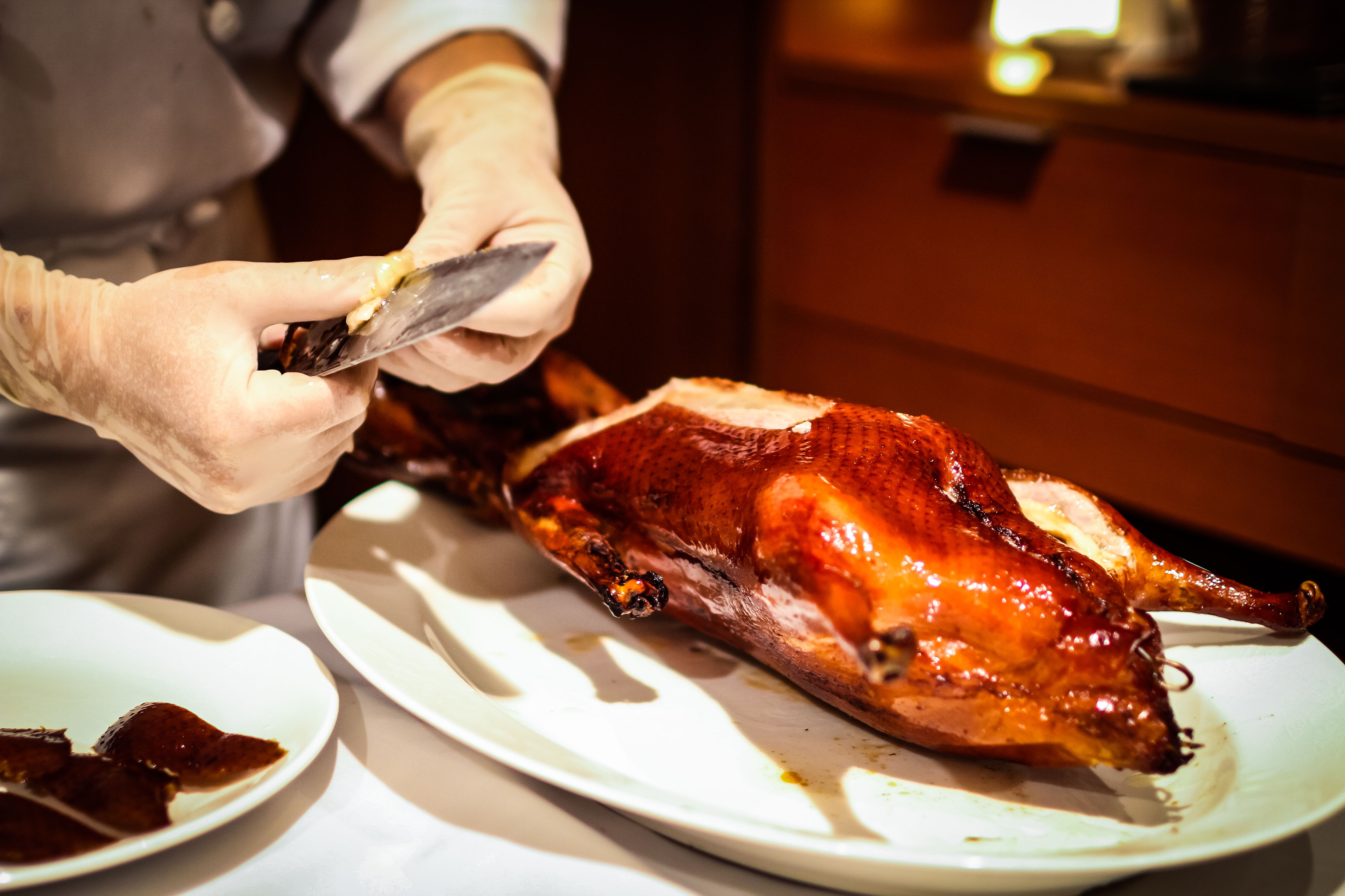 chef prepping some delicious pieces of traditional Peking duck