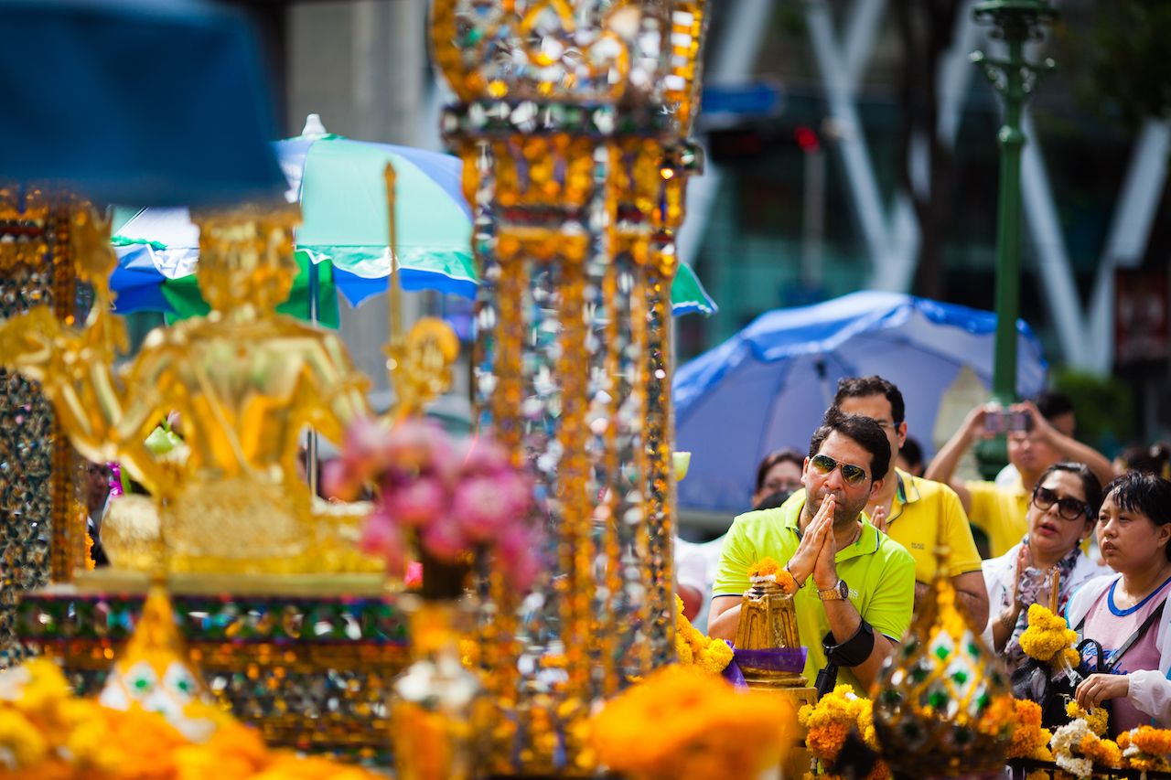 Thai people and tourists pray respect the famous Erawan shrine at Ratchaprasong
