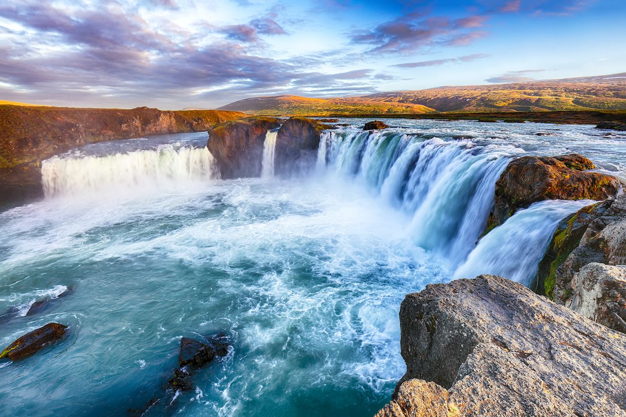 Breathtaking sunset landscape scene of powerful Godafoss waterfall. Dramatic sky over Godafoss. Location: Bardardalur valley, Skjalfandafljot river, Iceland, Europe most instagrammed