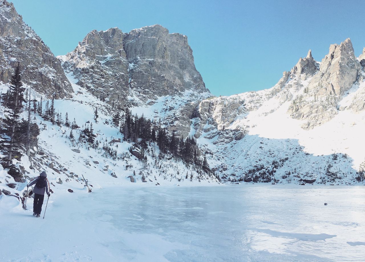 A person on a winter hike on the Dream Lake Trail in Rocky Mountain National Park
