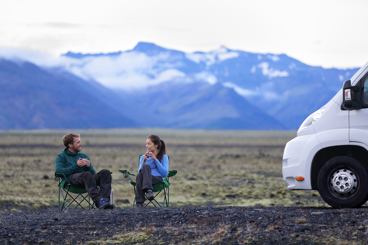 Travel couple by mobile motor home RV campervan