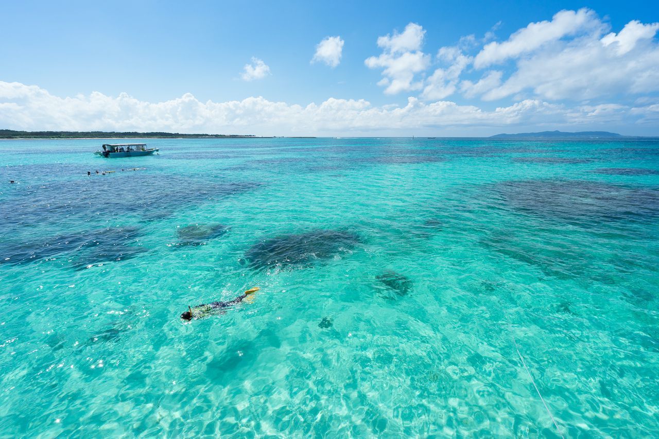 Man snorkeling in Tropical lagoon paradise of Ishigaki island, Okinawa, Japan