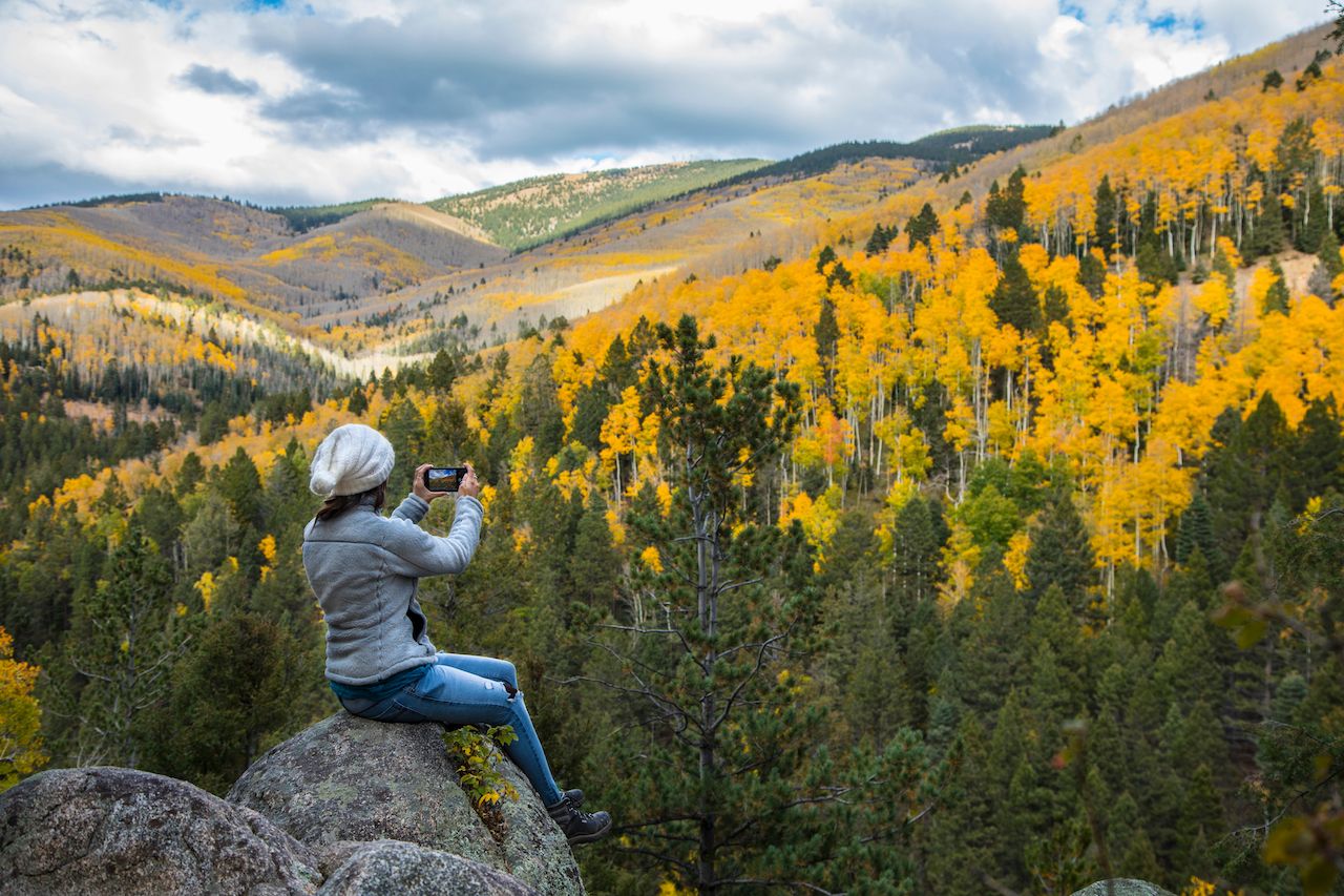 Woman sitting on a boulder near Santa Fe