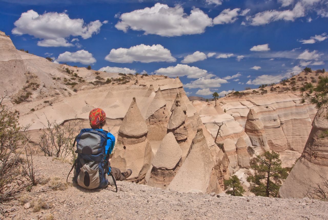 Hiker overlooking moon- like landscape in Kasha-Katuwe Tent Rocks National Monument